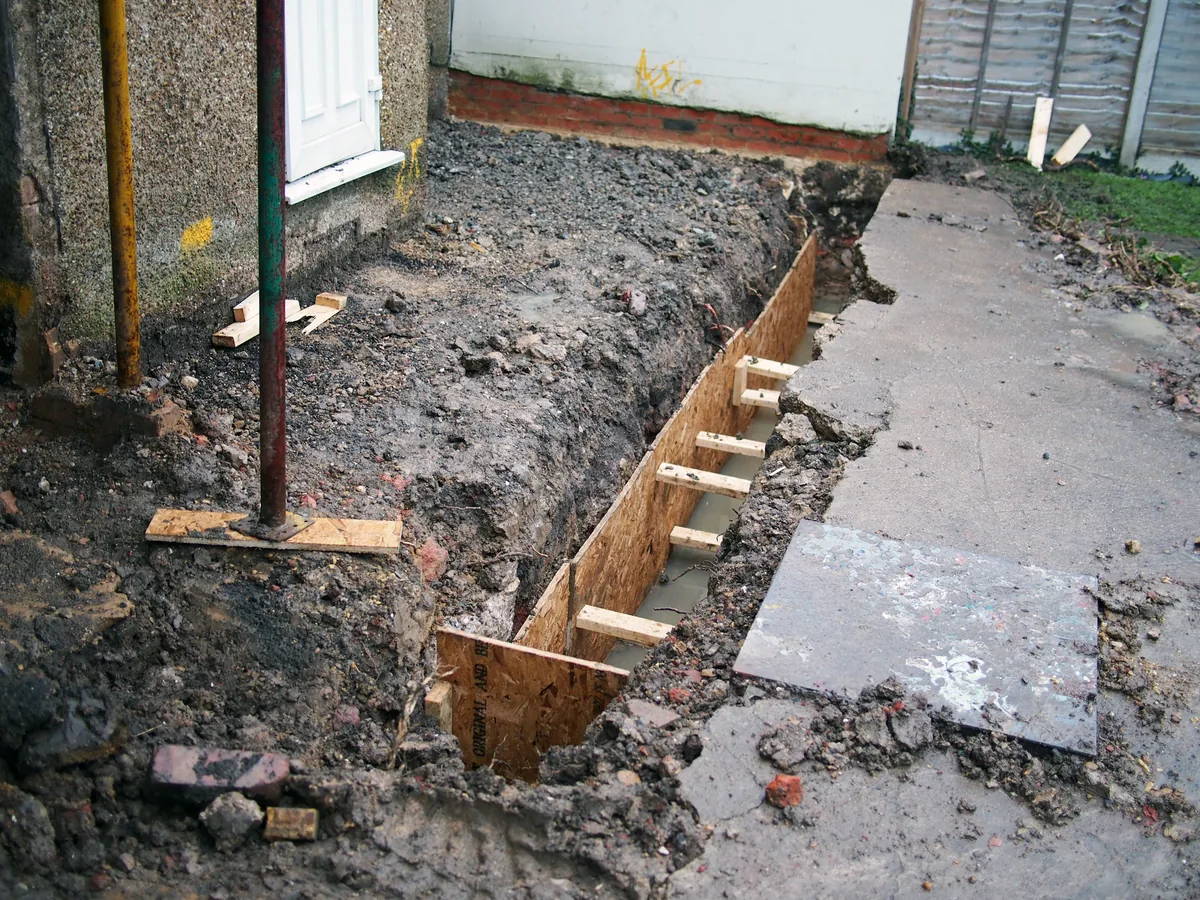 Massachusetts contractor performing basement waterproofing construction work