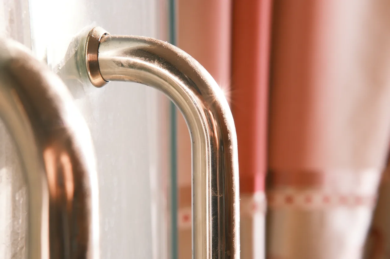 Master plumber installing emergency plumbing equipment in a Massachusetts home