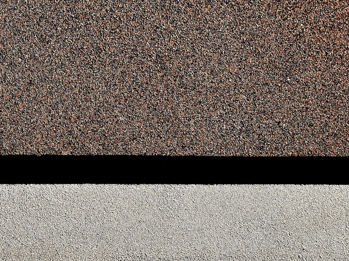 Roofer installing architectural shingles on a Massachusetts home